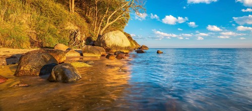 Coastal landscape with large boulders on the Baltic Sea beach in the evening light, Mönchgut Nature