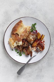 A plate with leftover pork kebab, with bread, on a white plate, close-up, there are no people