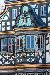 Killingerhaus, magnificent half-timbered house, colourful painted carvings on the bay window,