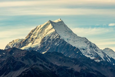 Serene beauty of Mount Cook in autumn, New Zealand. Snow capped peaks stand grand against a vivid