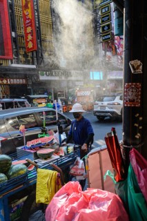 Bangkok, Thailand. February 18th 2025. A local street vendor pushes a cart loaded with watermelon