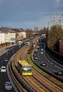 Essen, North Rhine-Westphalia, Germany - Cars and a public bus drive through Essen city centre on