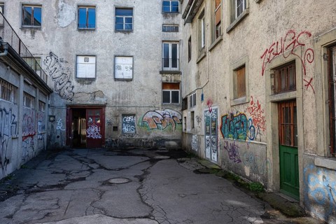 Dilapidated backyard in neglected and abandoned surroundings in downtown Constance with graffiti,