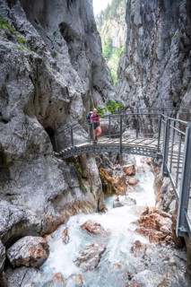 Hammersbach mountain stream in a canyon, mountaineer on a hiking trail in a gorge, Höllentalklamm,