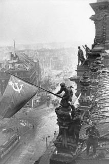 At the Berlin Reichstag, May 2, 1945, three Soviet soldiers fly the flag of the Soviet Union. The