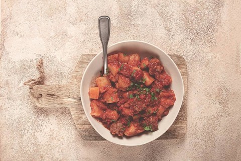 Stew with potatoes and vegetables, in tomato sauce, with spices and herbs, close-up, homemade, no