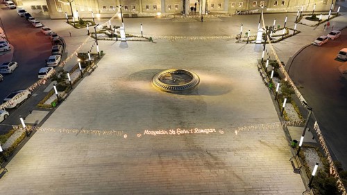 Aerial view captures hundreds of Muslims gathered at long tables for a communal Iftar meal in a