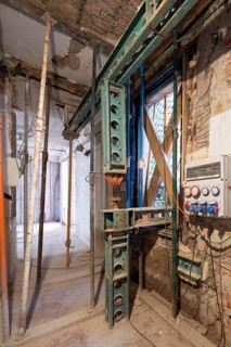 Industrial construction site showing metal support beams, exposed wiring, and a partially built