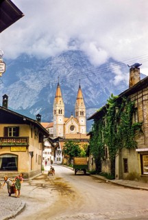 Village street with historic buildings leading to the parish church, Telfs, Tyrol, Austria, Europe