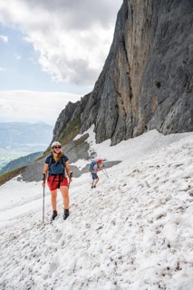 Mountaineer with helmet crossing a snowfield, ascent to the Ackerlspitze, Wilder Kaiser, Kaiser