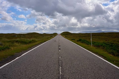 A long, lonely road stretches under a dynamic sky and stretches into the distance, Rannoch Moor,