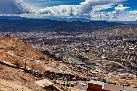 View of an extensive mountain landscape with a town in the valley below, The Silver Mines near