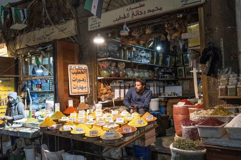 Damascus, Syria. December 10th 2025. A spice stall trader in Al-Buzuriyah Souq, a historical market