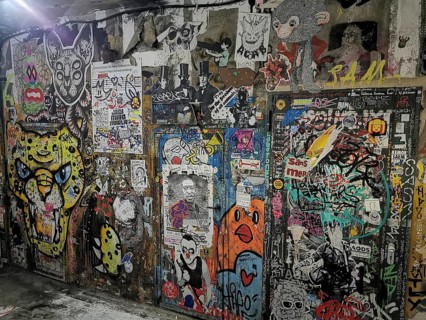 Wall with colorful graffiti and diverse illustrations in an urban environment, Berlin
