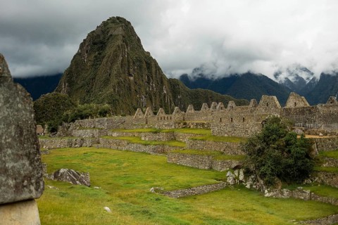 A breathtaking view of the ancient Inca citadel of Machu Picchu in Peru, showcasing lush greenery