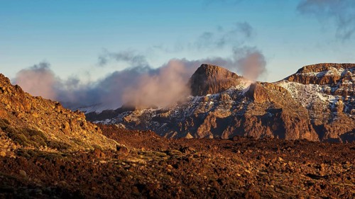 Mirador El Tabonal Negro, Caldera, view of snow-capped mountains with clouds in morning light,