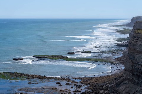 Rocky stretch of coast with cliffs and surf of the Atlantic Ocean, Rio Negro province, Argentina