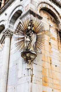 Mary with the Infant Jesus on the façade of the church of San Michele in Foro, historic city