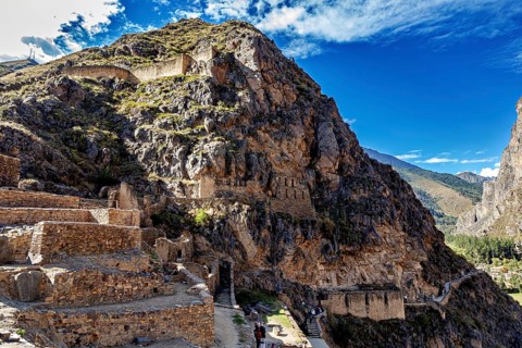 Inca ruins on a steep rock face in a mountainous landscape, The Inca ruins of Ollantaytambo in the