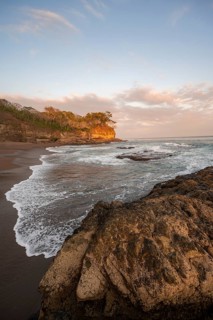 Sandy beach beach with rocks and sea at sunset, Playa Cocalito, coastal landscape, Pacific coast,