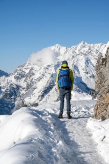 Mountaineers on the way to the Jenner summit with snow, snowy mountain panorama with Watzmann