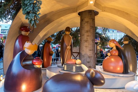 Large wooden crib figures in the middle of the Striezelmarkt Christmas market, Dresden, Saxony,