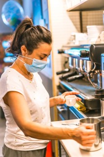 Photo session with a waitress with a face mask in a bar. New normality, security measures after the