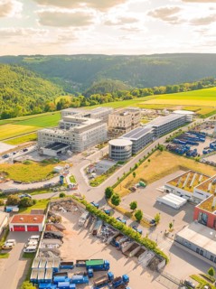 Industrial building in a green landscape, taken from a bird's eye view, construction of the new