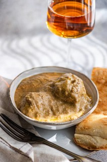 A traditional Georgian dish, Satsivi, features succulent chicken in a rich walnut sauce, elegantly