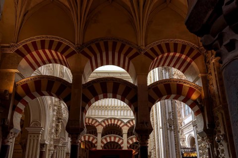 Impressive arched ceiling with red and white stripes inside the cathedral mosque of Córdoba