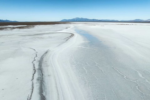 Expansive view of the stunning white salt flats of Salinas Grandes, Salta, Argentina, with distant