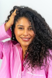 Studio portrait with white background of a cute latin woman posing sensual smiling at camera