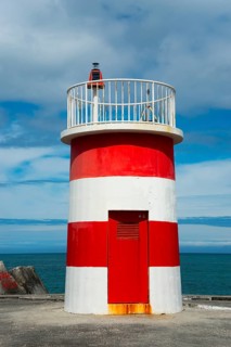 Small red and white lighthouse by the sea with dramatic sky and coastal view, lighthouse, Porto de