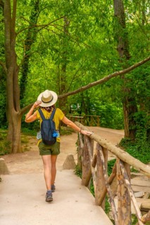 A tourist with a hat enjoying a walk in the Natural Park of the Monasterio de Piedra, Aragon