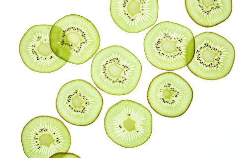 Bright and fresh kiwi slices arranged against a light background, showcasing the fruit vibrant