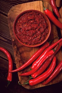 Red, Hot sauce, chili pepper, on a wooden table, no people, vertical, top view