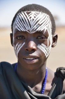 Young Maasai warrior with a painted face, Ngorongoro Conservation Area, Ndema, Tanzania