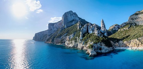 Picturesque rocky coast, cliffs with L'Aguglia pinnacle, blue sea and Cala Goloritzé beach, aerial