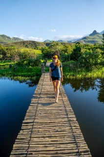 Young tourist on a jetty by a lake, Royal Natal National Park, Drakensberg Mountains south, Kwa