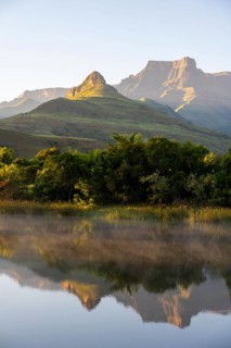 Sunrise, amphitheatre with reflection in the lake, Royal Natal National Park, Drakensberg Mountains