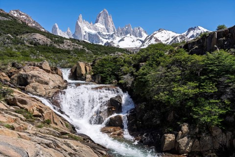 Chorrillo del Salto waterfall amidst rocky landscape with views of snow-capped Cerro Fitz Roy, Los