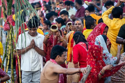 Hindu devotees gather on the banks of the Brahmaputra River to offer prayers to the Sun God on the