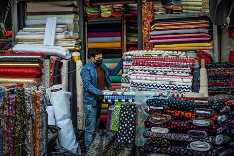 Istanbul, Turkey. November 28th 2020 A salesman wearing a protective face mask in the textile