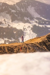 Person standing on snowy mountain enjoying the view of the surrounding winter landscape, Hochgrat