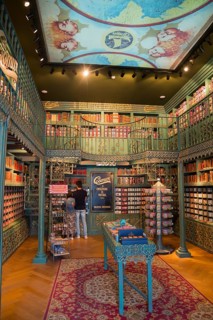Decorative antique-style shop with bookshelves and shelves full of colourful tins, cosy atmosphere