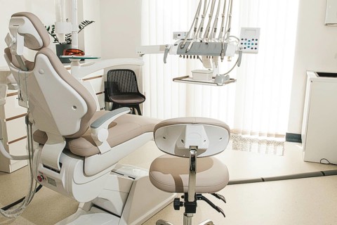 Modern dental clinic interior with equipment and patient chair ready for treatment
