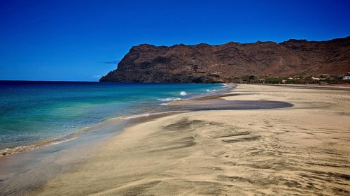 An extensive sandy beach on a clear coastline with calm waves, hiking, Sao Pedro, Sao Vicente, Cabo