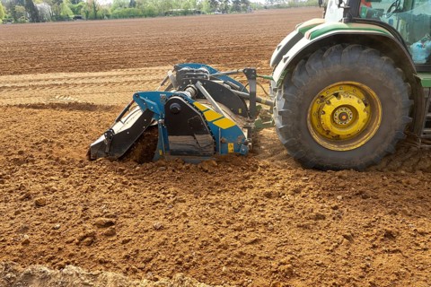 John Deere 8R 340 tractor engaged in field work operating an Agri-World FTC series soil tiller,