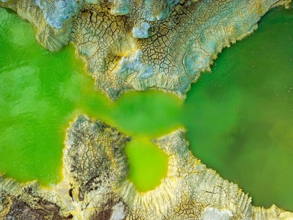 Aerial view of vibrant geothermal formations in Rotorua, New Zealand, showcasing stunning patterns