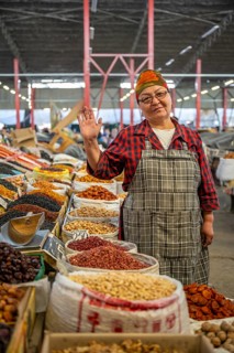 Traditional woman selling food, market stall at Osh Bazaar, Bishkek, Kyrgyzstan